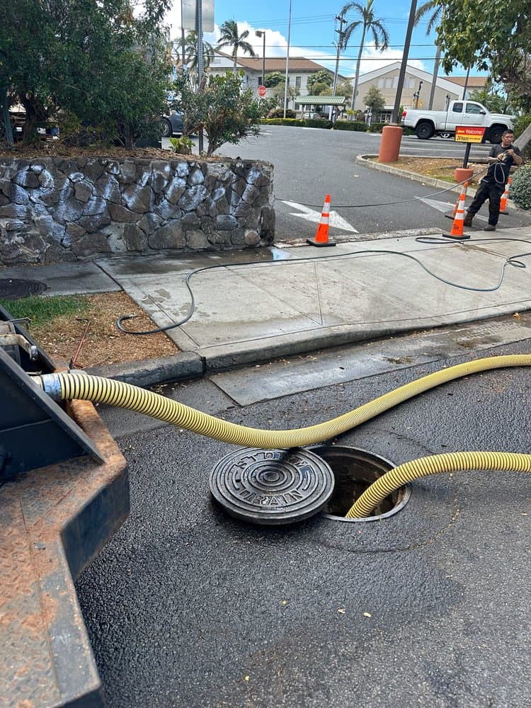 Alpha Omega Plumbing crew pumping a residential septic tank at an O'ahu property