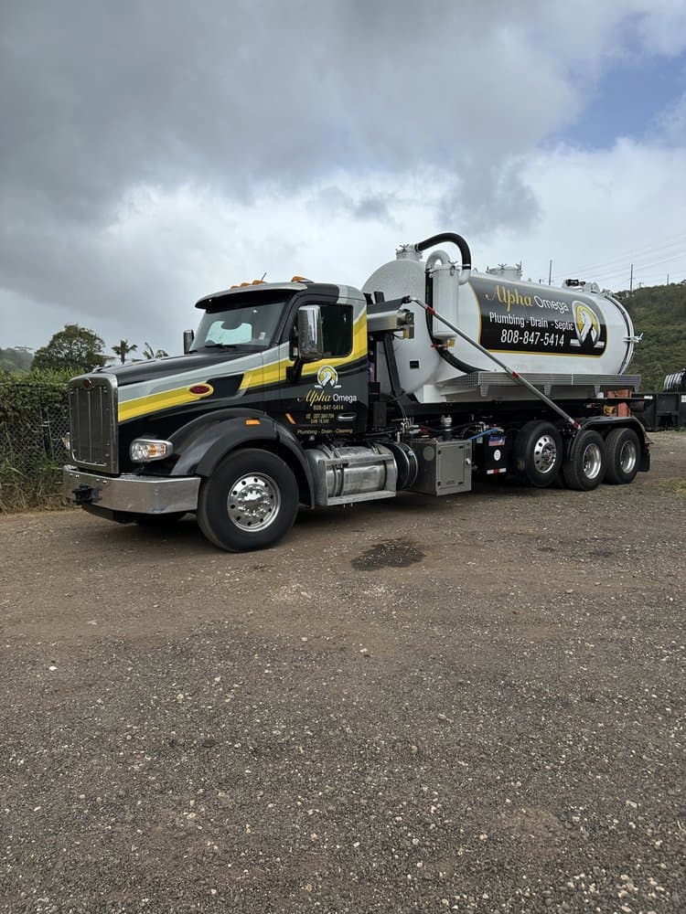Alpha Omega Plumbing pump truck servicing a residential septic tank on O'ahu, Hawai'i