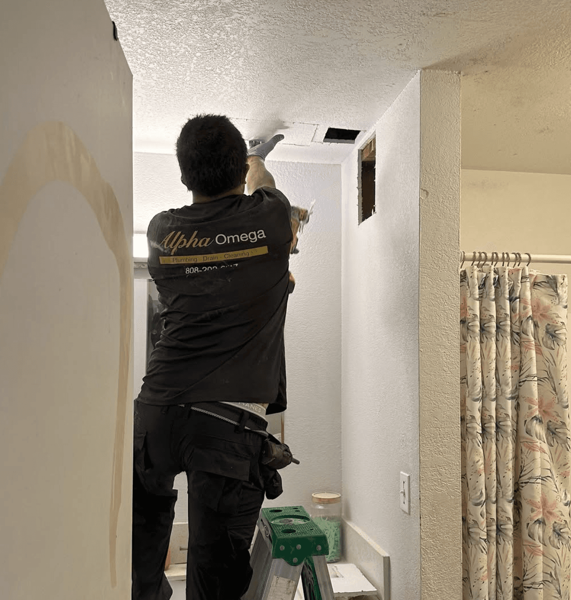 Alpha Omega tech doing interior repiping work in an Oahu home